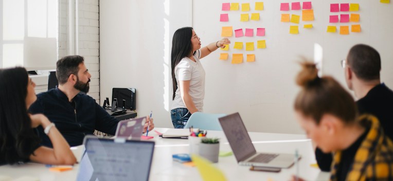 A strategy workshop with sticky notes on a wall