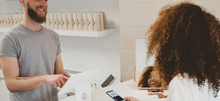 A cashier serving a customer at a counter